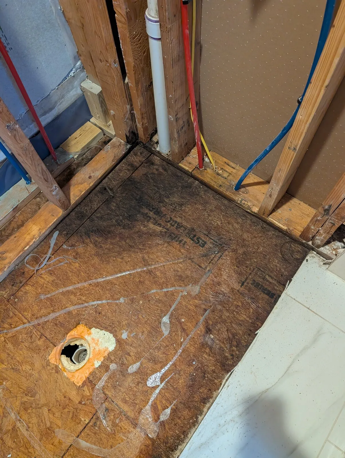 Bare subfloor across a room after the flooring was taken up.